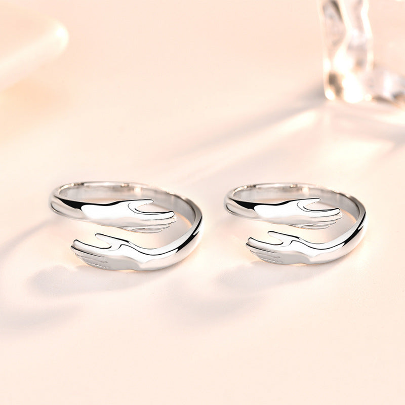 Silver hands hug couple ring