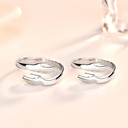 Silver hands hug couple ring