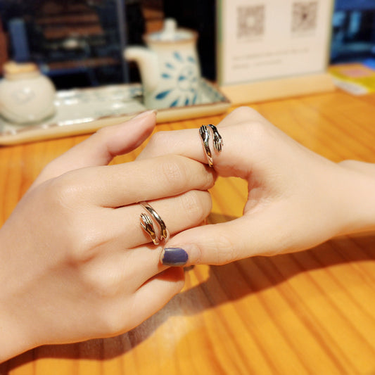 Silver hands hug couple ring