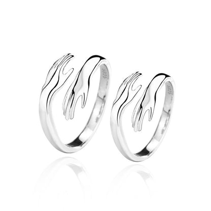 Silver hands hug couple ring